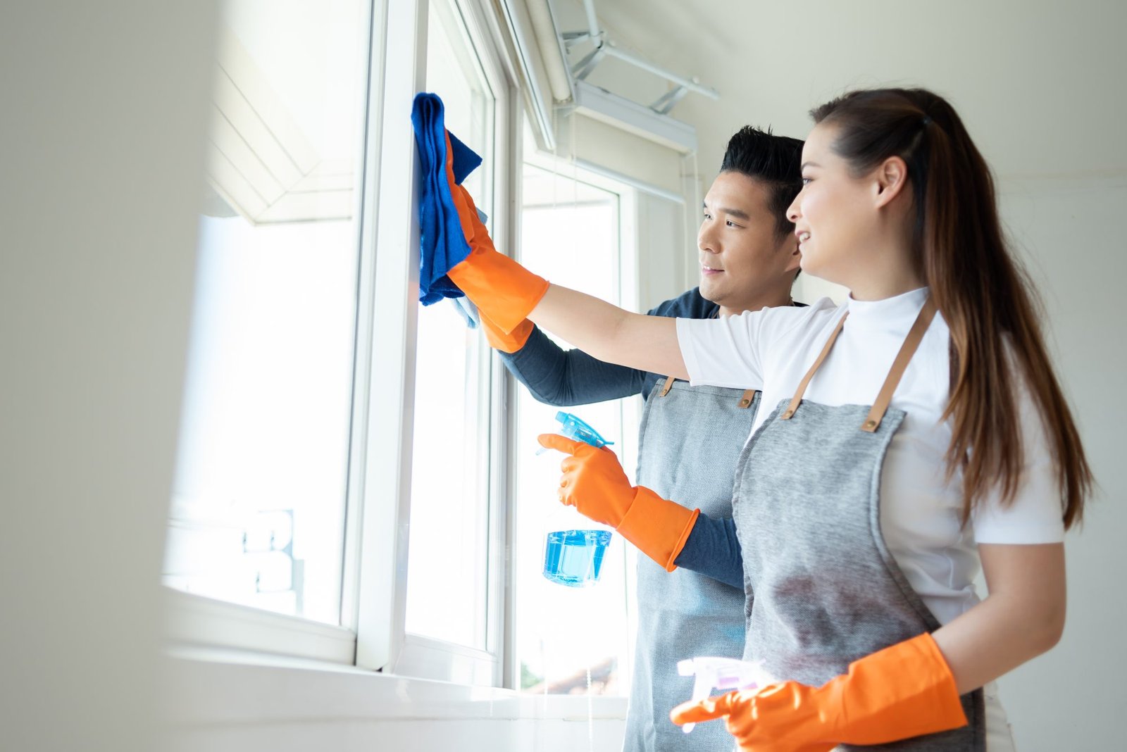 Mi Casa Cleaning Solutions  Young Asian Couple Cleaning House Together.